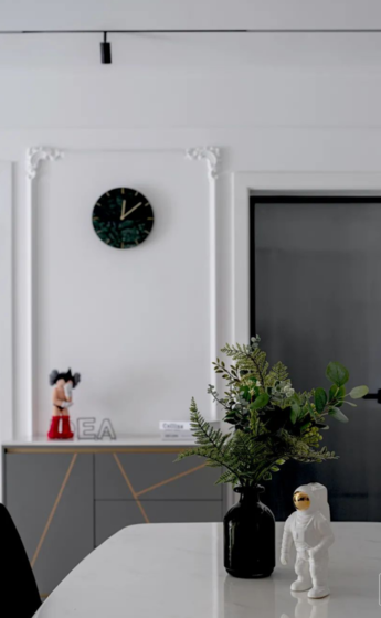 半金属的收纳柜与半浅橘色的背景墙呼应，半高灰色墙与灰色餐桌椅搭配，更显家的层次感和欧式高级感。